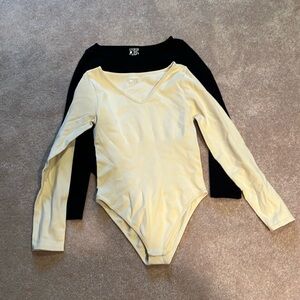 Set of 2 OQQ ribbed slimming bodysuits in black and white.